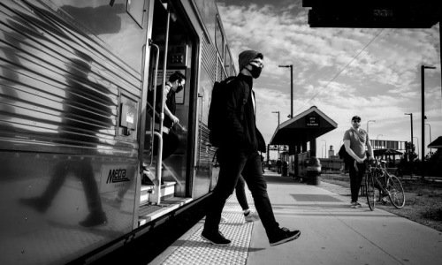 a man walking out of a train