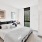 a bedroom with a bed and a desk