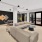 a clubhouse room with a large couch, a table and a chair