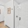a shower in a bathroom with white tiles