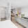 a studio with a bed, a couch and a kitchen area