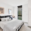 a bedroom with a bed and two nightstands
