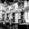 people sitting at tables in a cafe