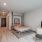 a bedroom with a bed and a tv