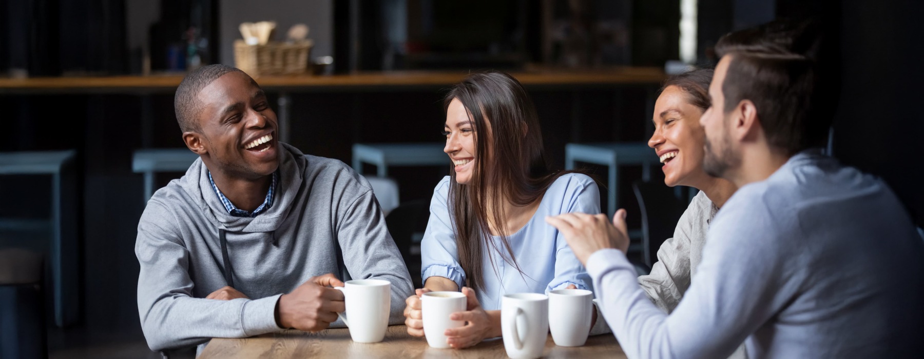 a group smiling with coffee