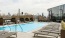 a pool with a deck and benches by it